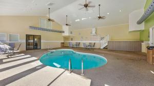 a large room with a blue pool in the middle at REFLECTIONS 2BD2BABalconyPoolsHottub-4PP in Lake Ozark
