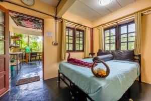 a bedroom with a bed with a basket on it at Slow-Down Homestay 2 in Koh Tao
