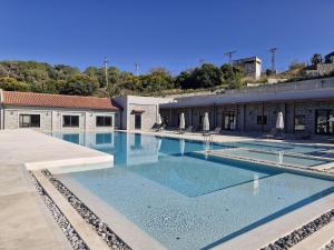 a large swimming pool in front of a building at Villa with Pool & View in Bitez in Bodrum City