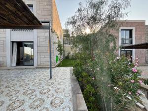 a courtyard of a house with a garden at Villa with Pool & View in Bitez in Bodrum City