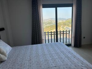 a bedroom with a bed and a large window at Villa with Pool & View in Bitez in Bodrum City +25 photos