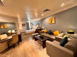 a living room with a couch and a table at Golden Tulip Al Khobar in Al Khobar +125 photos