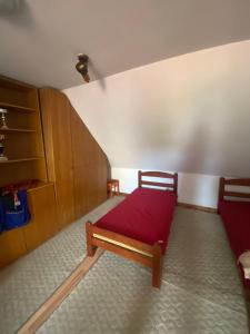a bedroom with a bed with a red blanket at Lana in Cetinje
