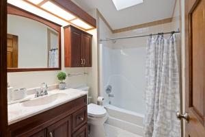 a bathroom with a sink and a toilet and a shower at 5 min to Lake Chic Cozy Hot Tub in Sparta +26 photos