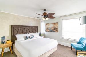 a bedroom with a bed and a ceiling fan at Inn on Charlotte Boutique Hotel in Saint Augustine