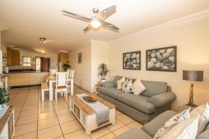 a living room with a couch and a table at Praslin 4 in Margate