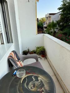 a table with a painting on it on a balcony at Center Oasis Retreat in Podgorica