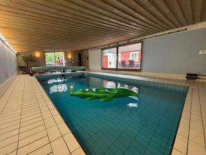 a swimming pool with a crocodile in the middle of it at Villa Kvarnbacken in Ljungbyholm