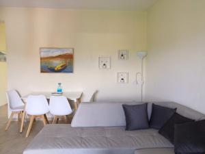 a living room with a couch and a table at Almond Apartments in Orfánion