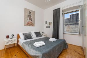 a bedroom with a bed with two towels on it at Rooms Heaven Door in Dubrovnik