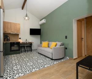 a living room with a couch and a kitchen at La casa di Antonio Corfu in Alepou