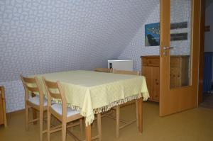 a table and chairs with a white table cloth on it at Ferienhaus Ahler Kopf in Lahnstein