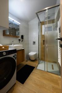 a bathroom with a shower and a sink and a washing machine at La casa di Antonio Corfu in Alepou +42 photos