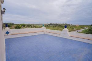 a balcony with a blue tile floor and a view at Himera Domus 2 in Termini Imerese