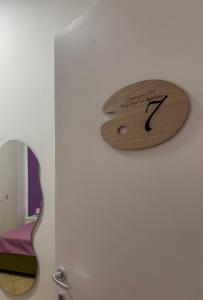 a wooden clock on a wall next to a guitar at Il dipinto in Reggio Calabria +21 photos