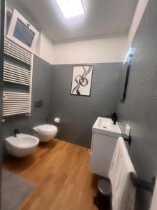 a bathroom with a white toilet and a sink at Pescara INN al Golf - Jack Nicklaus in Miglianico +24 photos