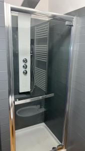 a shower in a bathroom with a glass door at Pescara INN al Golf - Jack Nicklaus in Miglianico