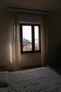a bedroom with a bed and a window with a view at Il Terrazzo Sul Castello in Lerici