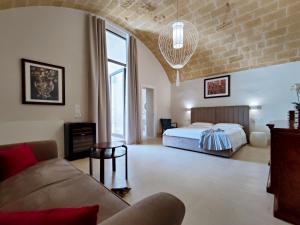 a living room with a bed and a couch at I Bastioni San Domenico - Boutique Hotel in Gallipoli +37 photos