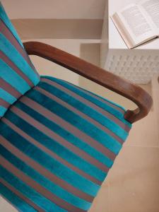 a chair with a book on a table at I Bastioni San Domenico - Boutique Hotel in Gallipoli