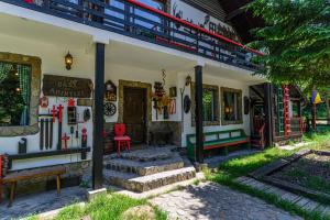 a house with a red chair and a red bench at Casa cu Amintiri - Authentic Cozy Cottage in Bran +91 photos