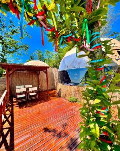a wooden deck with a tent and a tree at Opia Sapanca Bungalov in Sapanca