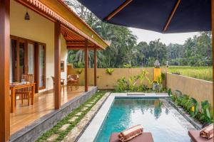 a house with a swimming pool and a patio at Uma rerama in Ubud