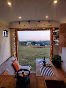 a room with a large window in a tiny house at Monroe Horsebox Glamping in Porthleven