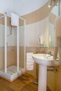 a bathroom with a sink and a shower at Palazzo Cappa-Affitti Brevi Italia in LʼAquila
