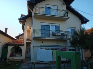a house with a clothes line in front of it at Smeštaj Golubica in Soko Banja
