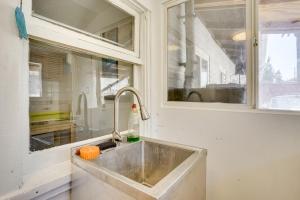 a kitchen counter with a sink and a window at 3 Mi to Beaches Low-Key San Pedro Rental! in San Pedro +18 photos