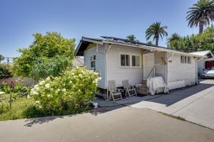 a white house with a table and chairs in a driveway at 3 Mi to Beaches Low-Key San Pedro Rental! in San Pedro