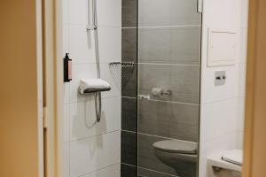 a bathroom with a toilet and a glass shower at Residhome Nanterre La Défense in Nanterre