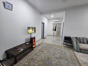 a living room with a couch and a table at Villa Atok Opah in Teluk Intan +13 photos