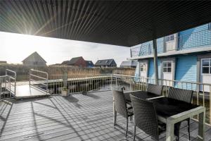 una terrazza con tavolo e sedie su una casa di 791-Hvide-Sande-Ae-Gammel-Havn-43 a Hvide Sande