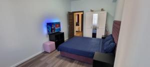 a small bedroom with a bed and a television at Monaco Summerland Rentals in Mamaia