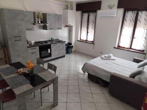 a kitchen and a living room with a bed and a table at Le dimore di Genny 2 in Medole