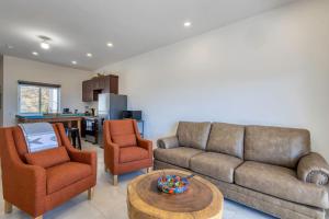 a living room with a couch and two chairs and a table at 2 BR Wake up to unique views from your balcony in Cabo San Lucas