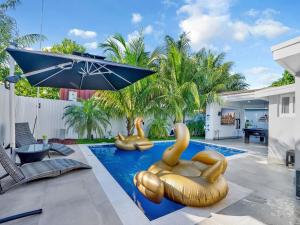 a swimming pool with yellow rubber ducks in the water at Luxury Villa with Heated Pool, Jaccuzzi, Gym, Games and More in Miami Gardens