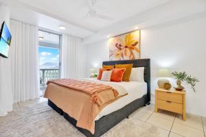 a bedroom with a large bed and a window at Skyview Luxe at Marquis in Cairns