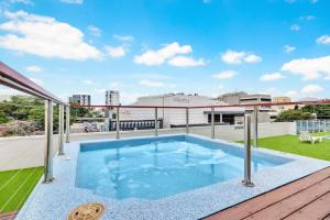 a swimming pool on the roof of a building at Skyview Luxe at Marquis in Cairns