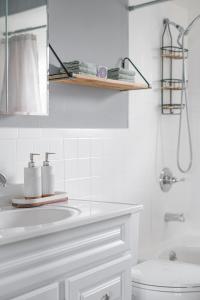 a white bathroom with a sink and a toilet at Cozy Home, 17 min from NYC, 2 Parking Spaces in Ridgefield Park