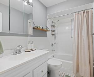 a white bathroom with a sink and a toilet at Cozy Home, 17 min from NYC, 2 Parking Spaces in Ridgefield Park +28 photos