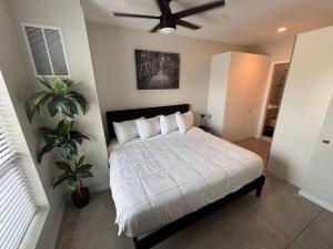 a bedroom with a bed with a ceiling fan at Charcoal Loft in Des Moines