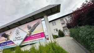 a building with posters on the side of it at Noclegi Pod Orłami in Lubaczów