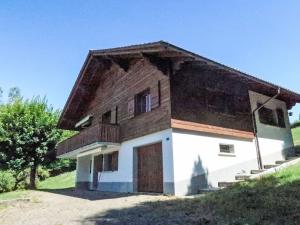 a house with a brown roof at Apartment Chalet Clairval by Interhome in Charmey