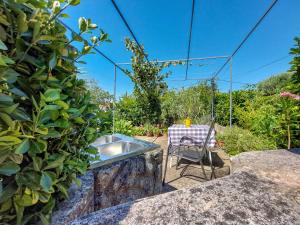 a table and a chair in a garden at Apartment Marija by Interhome in Sveti Vid-Miholjice
