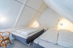 two beds in a room with a roof at 316-Hvide-Sande-Holmsland-Klitvej-115-ost in Hvide Sande