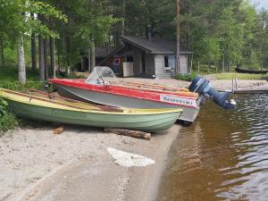 two boats are parked on the shore of the water at Holiday Home Kokkoranta by Interhome in Ilomantsi