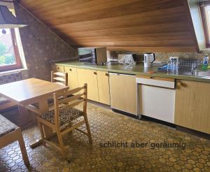 a kitchen with a table and a counter top at Küstenschwalbe in Wendtorf